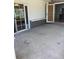 A concrete patio with sliding glass doors and a door to the exterior at 1811 Ridge S Rd, Largo, FL 33778
