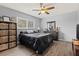 Comfortable bedroom featuring dark furniture, a ceiling fan, and a window that provides plenty of natural light at 2027 Montana Ne Ave, St Petersburg, FL 33703