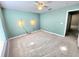 Carpeted bedroom with a ceiling fan and unique wall sconces at 2111 Roanoke Springs Dr, Ruskin, FL 33570