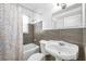 Updated bathroom features stylish tile surround, shower-tub combo, and modern fixtures at 2169 22Nd N Ave, St Petersburg, FL 33713