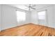 Bright bedroom featuring hardwood floors, a ceiling fan, and abundant natural light from two windows at 2169 22Nd N Ave, St Petersburg, FL 33713