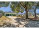 Exterior view of a single-story home with a covered carport and mature trees at 2169 22Nd N Ave, St Petersburg, FL 33713