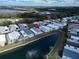 An aerial view of mobile homes in a vibrant community surrounding a picturesque lake with a fountain at 222 N Saint George Cir, Apollo Beach, FL 33572