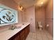 Cozy bathroom with decorative window, functional layout, and charming fixtures at 222 N Saint George Cir, Apollo Beach, FL 33572