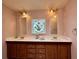 Charming bathroom with double sinks, decorative mirrors, and ample storage at 222 N Saint George Cir, Apollo Beach, FL 33572