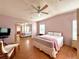 Inviting bedroom with ceiling fan, hardwood floors, ample closet space, and neutral decor at 222 N Saint George Cir, Apollo Beach, FL 33572