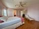 Cozy bedroom featuring a ceiling fan, light pink walls, and a cushioned lounge chair at 222 N Saint George Cir, Apollo Beach, FL 33572