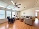 Bright living room with ceiling fan, skylight, lots of natural light, and comfortable seating at 222 N Saint George Cir, Apollo Beach, FL 33572
