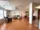 Spacious living room open to kitchen with hardwood floors, ceiling fan, and comfortable seating at 222 N Saint George Cir, Apollo Beach, FL 33572