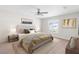 Cozy bedroom with ceiling fan, neutral carpet, and a large window for natural light at 2494 Caretta Ave, Spring Hill, FL 34609