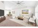 Bright living room with a ceiling fan, carpet flooring and a neutral color palette at 2494 Caretta Ave, Spring Hill, FL 34609