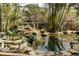 Screened outdoor koi pond with small waterfall and lush landscaping at 2965 Eagle Estates E Cir, Clearwater, FL 33761