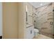 Modern bathroom with a glass-enclosed shower, new vanity and neutral color palette at 4006 N 27Th St, Tampa, FL 33610