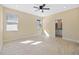 Bright bedroom with a ceiling fan, tile flooring, and en suite bathroom at 4006 N 27Th St, Tampa, FL 33610