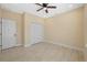 Well-lit bedroom has tile flooring, a ceiling fan, closet and neutral colored walls at 4006 N 27Th St, Tampa, FL 33610