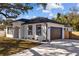 Charming home featuring a dark roof, a two-car garage, and a well-manicured lawn at 4006 N 27Th St, Tampa, FL 33610