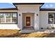 Inviting entrance with a red front door, modern lighting and meticulously maintained landscaping at 4006 N 27Th St, Tampa, FL 33610