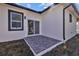 Concrete patio space featuring sliding glass doors and views of the backyard space at 4006 N 27Th St, Tampa, FL 33610
