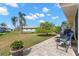 Inviting back patio with comfortable seating, lush landscaping, and paver flooring at 410 Faraday Trl # A, Sun City Center, FL 33573