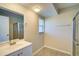 Well-lit bathroom with a vanity, shower, and wood-look tile flooring at 5043 Escalante Dr, North Port, FL 34287
