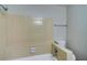 Neutral-tiled bathroom featuring a tub with shower and toilet at 5043 Escalante Dr, North Port, FL 34287