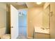 Bright bathroom featuring a white vanity, toilet, and an open doorway to a carpeted bedroom at 5043 Escalante Dr, North Port, FL 34287