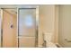 Clean bathroom with a glass-enclosed shower and a white toilet with matching tile at 5043 Escalante Dr, North Port, FL 34287