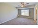 Sunny bedroom with a window and ceiling fan, carpeted floor, and neutral walls at 5043 Escalante Dr, North Port, FL 34287