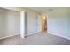 Bedroom featuring closet and bathroom entrance; ceiling fan and neutral carpeting at 5043 Escalante Dr, North Port, FL 34287