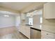 Bright kitchen with white cabinets, stainless steel appliances, and breakfast bar at 5043 Escalante Dr, North Port, FL 34287