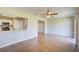 Spacious room featuring tile floors and a ceiling fan open to the kitchen at 5043 Escalante Dr, North Port, FL 34287