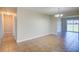 Spacious living room showcasing tile flooring that connects to the hallway and sliding glass doors at 5043 Escalante Dr, North Port, FL 34287