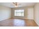 Inviting living space features tile flooring, a front door, a ceiling fan, and a window with blinds at 5043 Escalante Dr, North Port, FL 34287