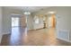 Bright living area with tile flooring that connects to the kitchen, sliding doors, and white cabinets at 5043 Escalante Dr, North Port, FL 34287