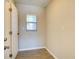 Small bonus room with tile flooring, window with blinds, and access door at 5043 Escalante Dr, North Port, FL 34287