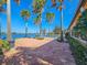 Backyard with a patio, palm trees, and waterfront views at 5062 Stone Harbor Cir, Wimauma, FL 33598