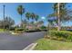 The Club Valencia Grande community entrance sign with lush landscaping and palm trees at 5062 Stone Harbor Cir, Wimauma, FL 33598