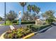 The Club Valencia Grande community entrance sign with colorful flowerbeds and manicured landscaping at 5062 Stone Harbor Cir, Wimauma, FL 33598