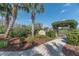 The entrance to the community garden is marked by a sign, palm trees, and an arbor at 5062 Stone Harbor Cir, Wimauma, FL 33598
