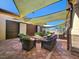 Inviting outdoor patio with comfortable seating and shaded cover for relaxing and entertaining by the pool at 5062 Stone Harbor Cir, Wimauma, FL 33598