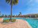Community pool with palm tree landscaping, lounge seating and shallow access entry points at 5062 Stone Harbor Cir, Wimauma, FL 33598