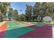 Community shuffleboard court with shaded seating, colorful play surface, and well-maintained landscaping at 5062 Stone Harbor Cir, Wimauma, FL 33598