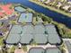 Aerial view of multiple tennis courts and other sports courts within the community at 5062 Stone Harbor Cir, Wimauma, FL 33598