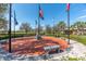 Community's Veteran's Memorial featuring flags, benches, and a decorative brick surface at 5062 Stone Harbor Cir, Wimauma, FL 33598