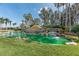 Community entrance with water feature, waterfalls, lush landscaping and pond at 5062 Stone Harbor Cir, Wimauma, FL 33598