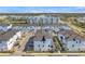 Community aerial view featuring manicured landscaping and neatly arranged townhomes near a pond at 5351 Bridge St # 81, Tampa, FL 33611