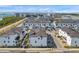 An aerial view highlights the community's modern townhomes, streets, landscaping and stunning waterfront location at 5351 Bridge St # 81, Tampa, FL 33611