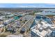 A panoramic aerial view of a lakeside community with modern townhomes, a fountain, and lush green spaces at 5351 Bridge St # 81, Tampa, FL 33611