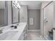 Bathroom with double vanity featuring undermount sinks, chrome fixtures and walk-in shower with glass door at 5351 Bridge St # 81, Tampa, FL 33611