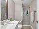 Bathroom featuring light walls, wood-look flooring, toilet and shower with white tiles and glass door at 5351 Bridge St # 81, Tampa, FL 33611